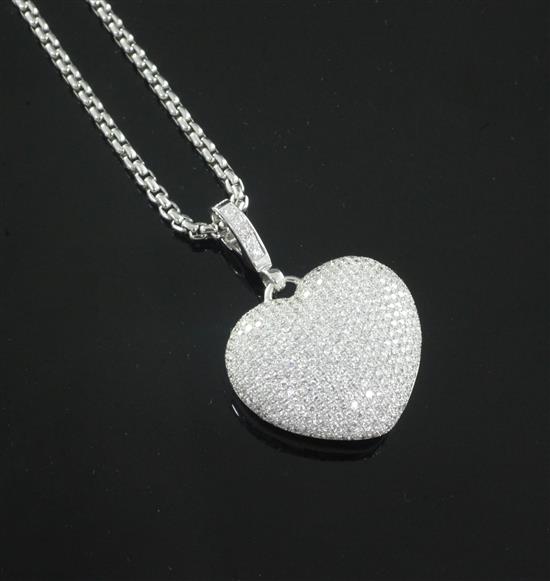 A Theo Fennell Art 18ct white gold and diamond encrusted heart shaped pendant, with diamond set bale, on a Fope chain.